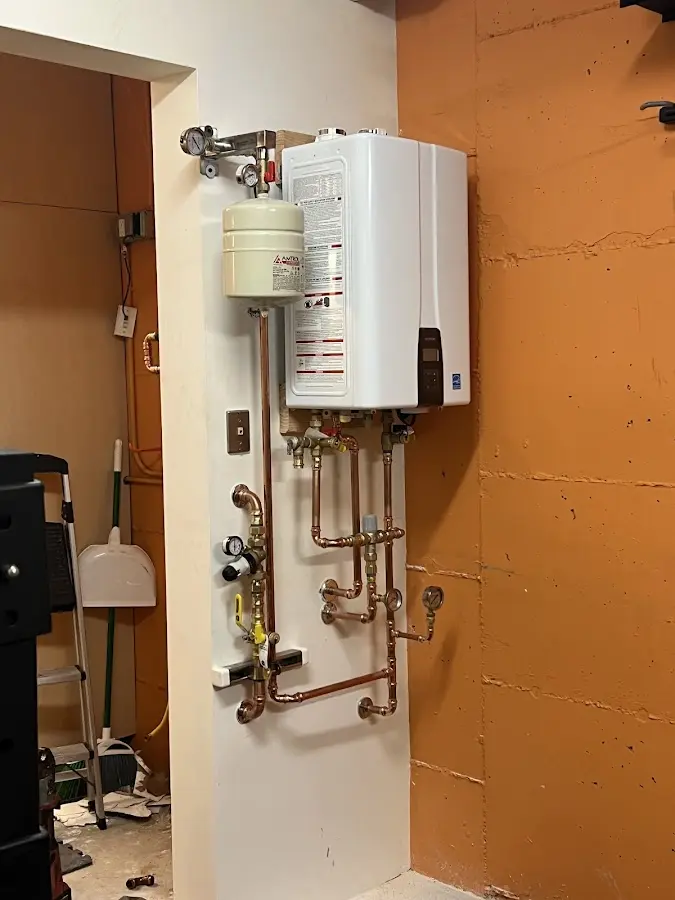 Plumbing technician inspecting water heater connections in Seacliff